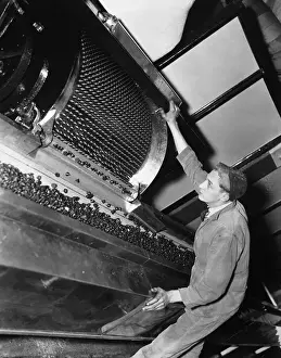 Hershey Prints: Man Watches Machine Making Hershey's Kisses in Factory