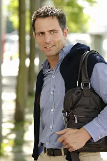Man wearing casual clothes standing in an avenue