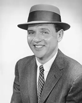 Man wearing hat, posing in studio, (B&W), portrait