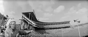 Man Wearing an Indian Headdress at a Stadium