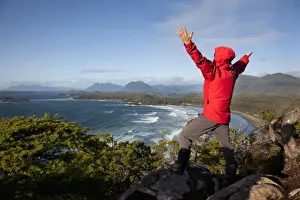 Rain Forest Prints: A Man Wearing A Red Jacket Looks Out At The View Of Cox Bay Near Tofino With Arms Raised