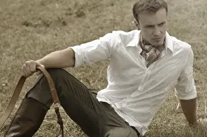 Riders Prints: Man wearing riding clothes sitting in a field in summer