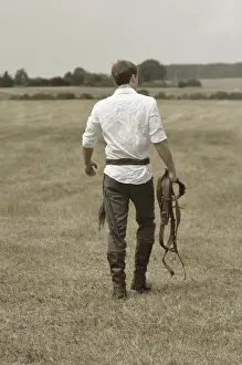 Riders Prints: Man wearing riding clothes walking in a field in summer