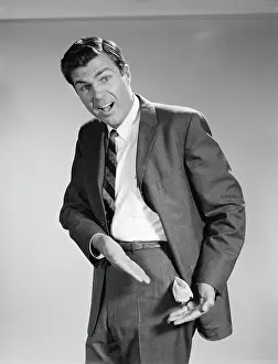 Suit Prints: Man wearing suit, looking distressed, pointing to empty pocket pulled out of pants
