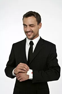 Images Dated 15th August 2012: Man wearing a suit pulling an ace of hearts out of his sleeve