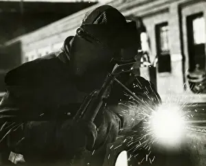 Man welding outdoors