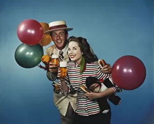 Images Dated 8th July 2016: Man and woman with balloons and refreshments
