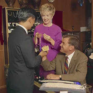Shop Assistant Prints: Man and woman buying pearl necklace in shop