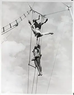Man And Woman Doing High Wire Act