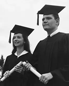 Graduation Prints: Man and woman in graduation caps and gowns