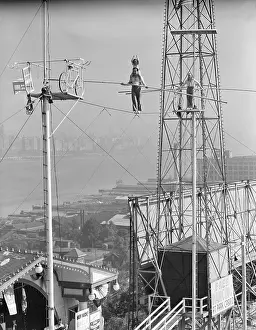 Tightrope Prints: Man and Woman Holding Pole on Highwire