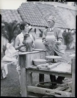 Pottery Prints: Man, Woman At Old Foot-Driven Pottery Wh