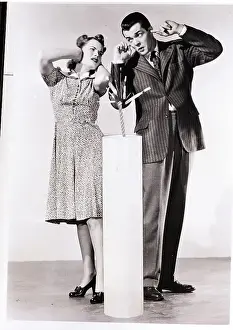 Covering Prints: Man and Woman Pose with Giant Firecracker