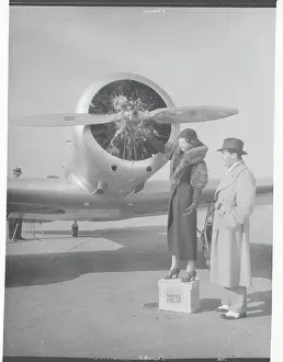Man and Woman Standing Near Airplane