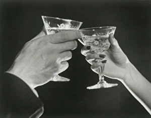 Images Dated 28th February 2008: Man and woman toasting martini glasses, close up of hands