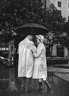 Man and woman under umbrella, color enhanced