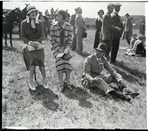 Man And Women Seated On Lawn At Race