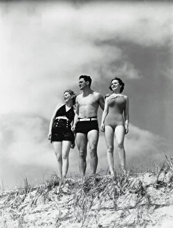 Sand Dune Gallery: Man and two women standing on beach sand dune