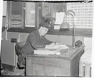 Prints of (Original Caption). The Department Answering Raid Alarm office in New York City is shown, which was founded after the attack on Pearl Harbor Pearl Harbor Prints: Man Working in Department Answering Raid Alarm Office