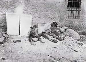 Man and Young Boy Sitting and Working With Minerals
