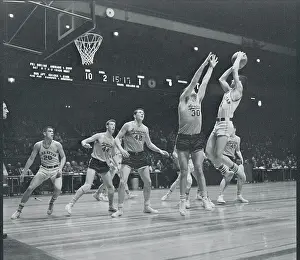 Manhattan and Syracuse Players Playing Hard on the Court