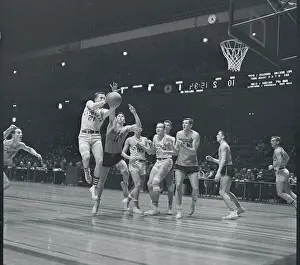 Manhattan and Syracuse Players Playing Hard on the Court