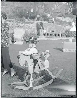 Edward G Prints: Mannie Robinson Riding a Rocking Horse