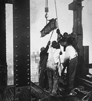 Prints of circa 1930: A group of men hauling a girder up into a skyscraper they are building high above New York. (Photo by General Photographic Agency/Getty Images) Daredevil Construction Worker Prints: Manpower