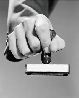Only Mature Men Prints: Man's hand holding rubber stamp, poised about to stamp