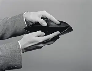 Mans hands holding open empty wallet. (Photo by H. Armstrong Roberts / Retrofile / Getty