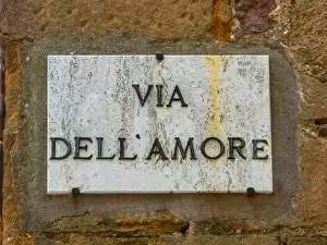 Brick Wall Prints: Marble street sign in Pienza, Tuscany, Italy, a UNESCO heritage site