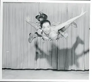 Margie Lee Gazing up to Ceiling as She Performs Ice Skating Maneuver