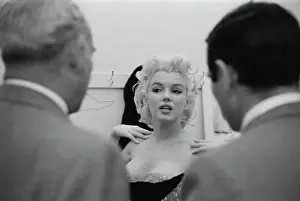 Prints of American actress Marilyn Monroe (1926 - 1962) gets fitted for her costume in a dressing room before riding a pink elephant in Madison Square Garden for a circus charity event in New York City, US Marilyn Monroe: The Iconic Muse Prints: Marilyn Costume Fitting