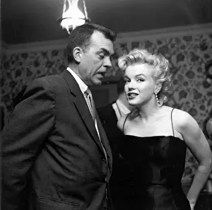 Prints of LOS ANGELES - MARCH 3: Movie star Marilyn Monroe chats with guests during a press party at her home on March 3, 1956 in Los Angeles, California. (Photo by Earl Leaf/Michael Ochs Archives/Getty Images) Marilyn Monroe: The Iconic Muse Prints: Marilyn At Home With Guests