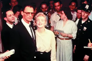 Marilyn Monroe and Arthur Miller Posing in Front of Press Group