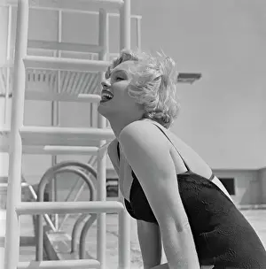 Prints of (Original Caption). Marilyn Monroe, curvaceous film star, entered the dispute on the bikini, French bathing suit and bared her preference for same Marilyn Monroe: A Fashion Legacy: Marilyn Monroe in Bathing Suit Laughing