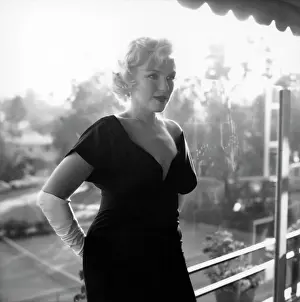 Prints of BEVERLY HILLS, CA - JULY 8: Actress Marilyn Monroe attends a party held in her honor wearing a black dress and white gloves at the Beverly Hills Hotel on July 8, 1958 in Beverly Hills, California Marilyn Monroe: The Iconic Muse Prints: Marilyn Monroe At The Beverly Hills Hotel