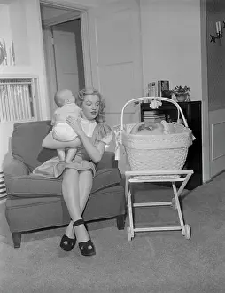Marilyn Monroe Holding Baby on Couch