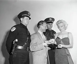 Displaying Prints: Marilyn Monroe with Jewelry Expert and Guards