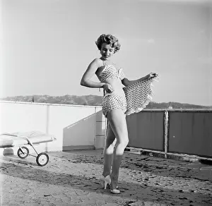 Prints of American actress Marilyn Monroe (1926 - 1962) wearing polka dot bikini with matching wraparound miniskirt and heels during a photo shoot on a rooftop, circa 1951 Marilyn Monroe: The Iconic Muse Prints: Marilyn Monroe in Polka Dot Bikini