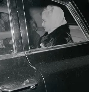 Marilyn Monroe Wearing a Scarf and Sitting in Car