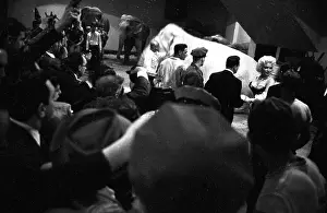 Prints of NEW YORK - MARCH 1955: Movie star Marilyn Monroe rides a pink elephant in Madison Square Garden for a circus charity event as she is surrounded by photographers in March 1955 in New York City Marilyn Monroe: The Iconic Muse Prints: Marilyn Rides A Pink Elephant