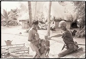 Marine Directs Viet Cong People from Burning Home
