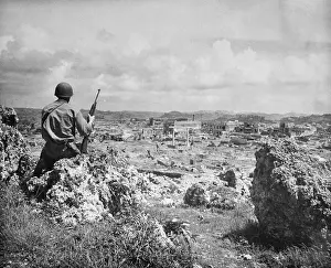 US Marine Looks Over Destroyed City