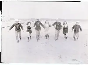 Marines Running on Beach with Women