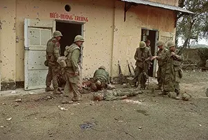 Marines Standing with Wounded Soldier