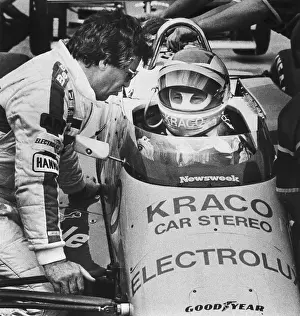 Mario Andretti Talking with his Son in Race Car