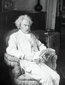 Hartford Prints: Mark Twain Reading A Book In Easy Chair