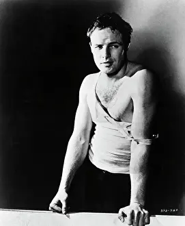 Prints of (Original Caption). Marlon Brando as he appeared in the 1951 film, A Streetcar Named Desire. He is shown wearing a ripped white tank shirt The Iconic Moments Captured: Marlon Brando as Stanley Kowalski