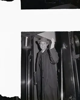 Prints of (Original Caption) 11/24/54-Paris, France- Actor Marlon Brando, looking more like a well-dressed businessman than a film star The Iconic Moments Captured: Marlon Brando Waving from Train